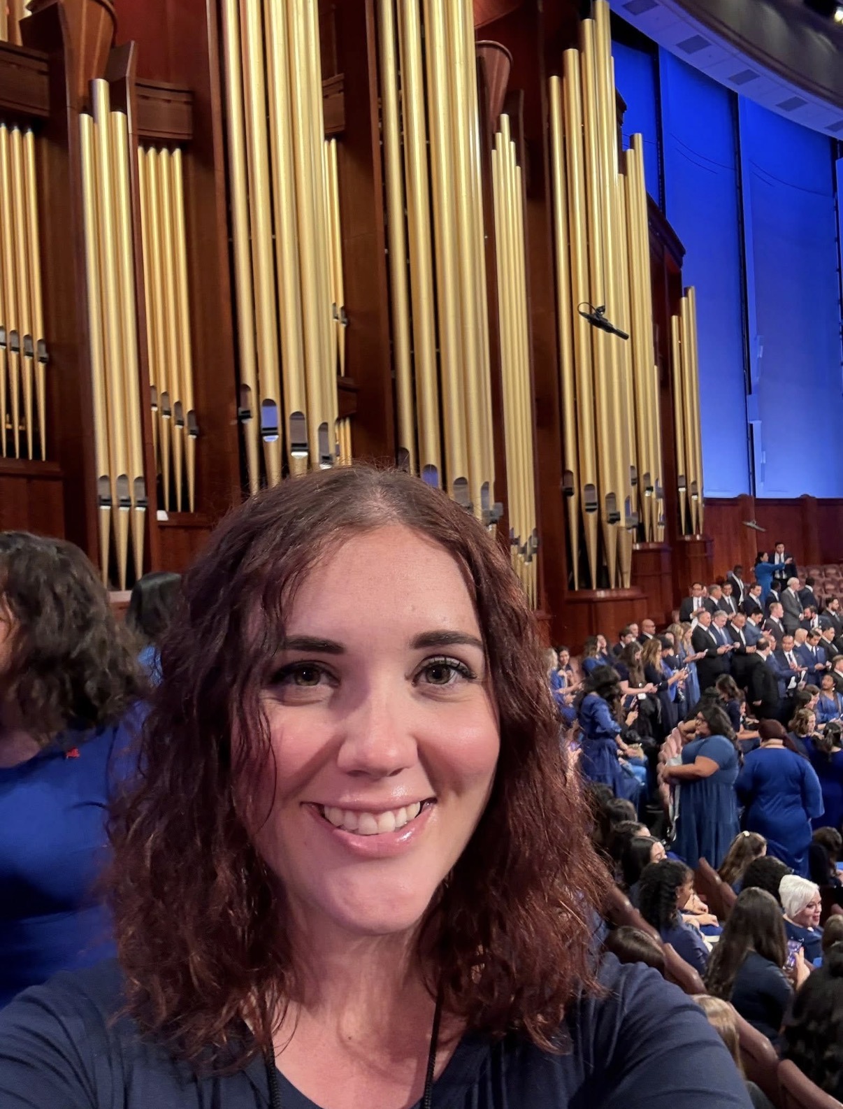 Kate at a choir performance in front of the organ pipes